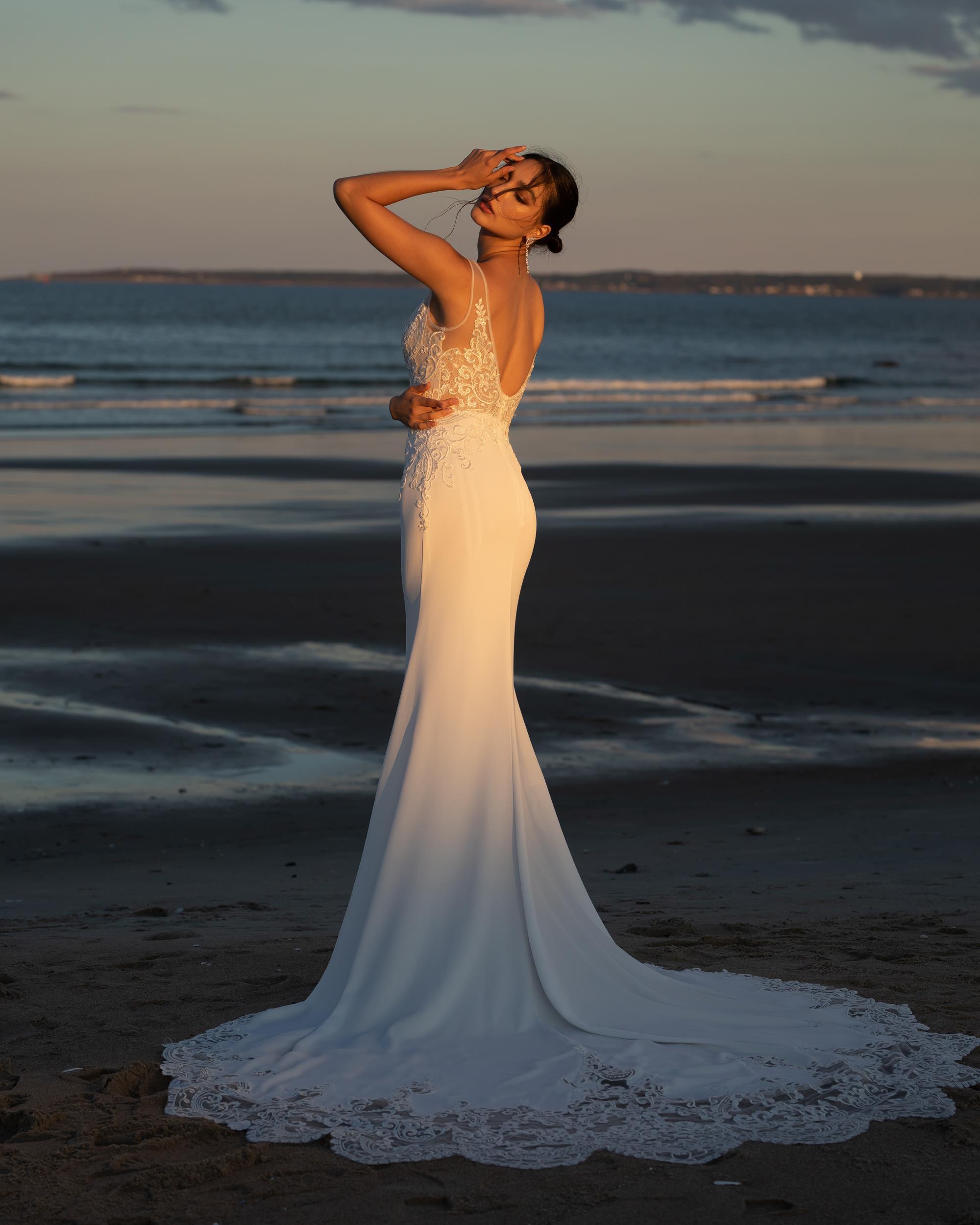 Photo of the model wearing a bridal gown near the beach